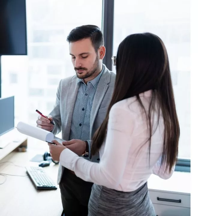 Two people looking at paperwork